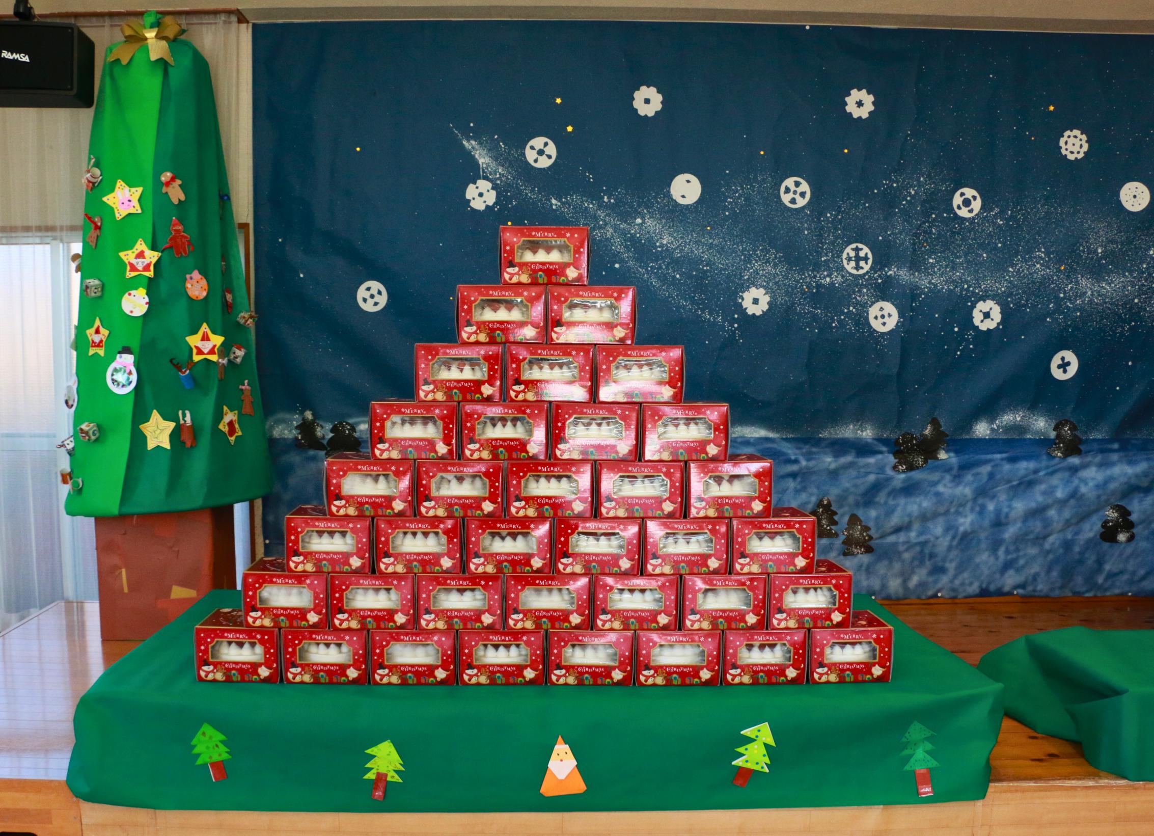 ピラミッド型に積まれた箱に入ったケーキの写真